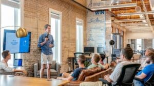 Image Source: https://unsplash.com/photos/rxpThOwuVgE  Image Text: Social Team Event Alt-Text: Hackathon Corporate Event Description: Team Discussing Innovative Solutions at a Hackathon