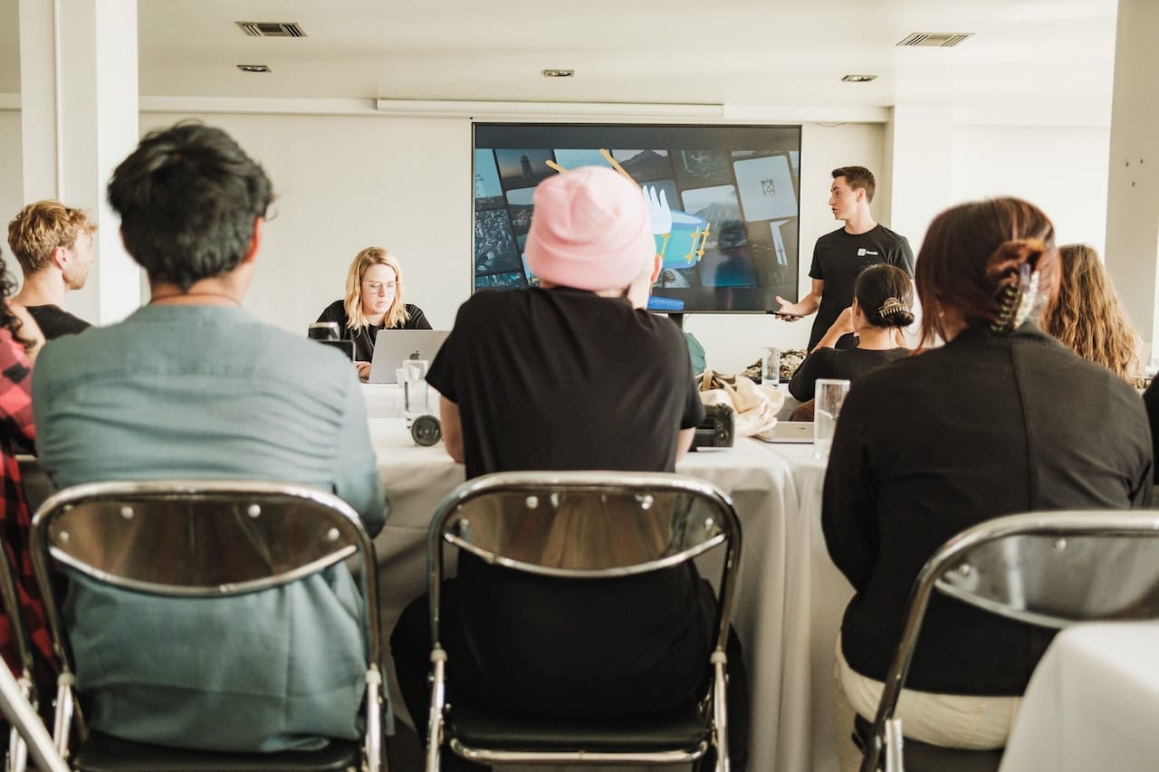 Image Title: The Grand Symphony of Meetings Image Description: A meeting planner is briefing their team on the next event Alt Text: Behind-the-Scenes with Meeting Planners Source: https://www.pexels.com/photo/restaurant-man-people-woman-15189553/