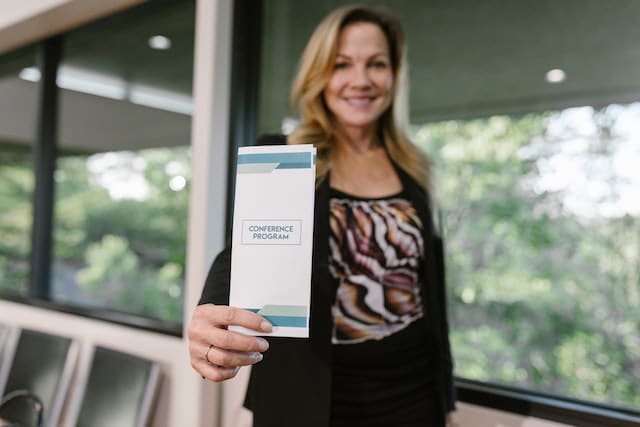 Photo by RDNE Stock project: https://www.pexels.com/photo/a-woman-holding-a-conference-program-pamphlet-7648516/ -- print