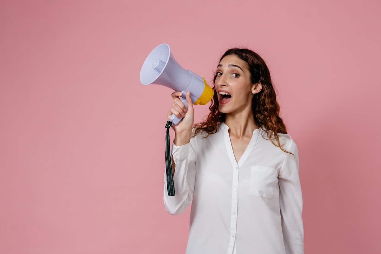 Photo by Pavel Danilyuk: https://www.pexels.com/photo/woman-in-white-button-up-long-sleeve-shirt-holding-a-megaphone-8638300/ -- announcement
