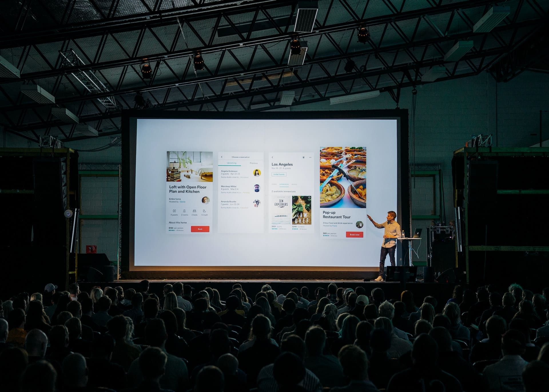 Image Text: Well-planned and smoothly executed events are always memorable Alt-Text: Crafting memorable events Image Description: A person discussing while standing in front of a large screen Image Source: https://unsplash.com/photos/bzdhc5b3Bxs