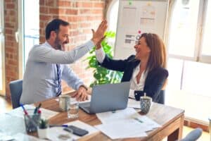Image Title: Partnership Celebrated in Unity Image Description: Two professionals share a high-five in a vibrant office setting Alt Text: Partnership High-Five Source: https://unsplash.com/photos/man-in-white-dress-shirt-sitting-beside-woman-in-black-long-sleeve-shirt-376KN_ISplE