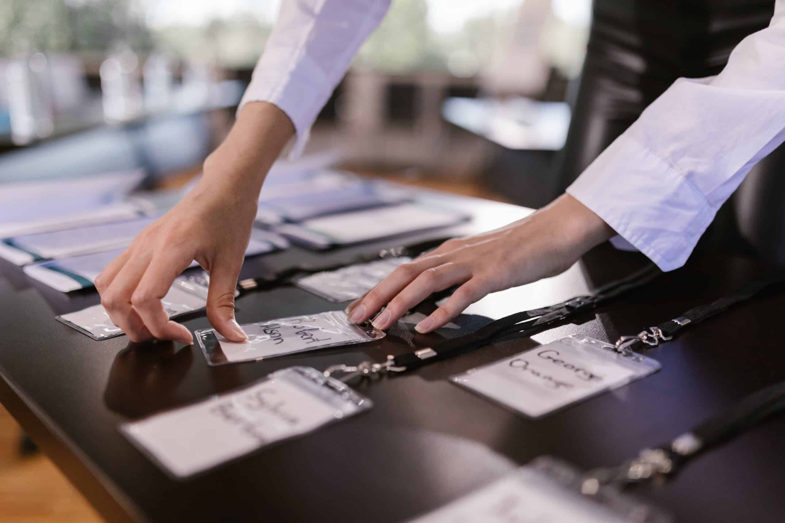 Corporate Event Planner Photo by RDNE Stock project: https://www.pexels.com/photo/person-arranging-name-tags-with-laces-on-a-desk-7648472/