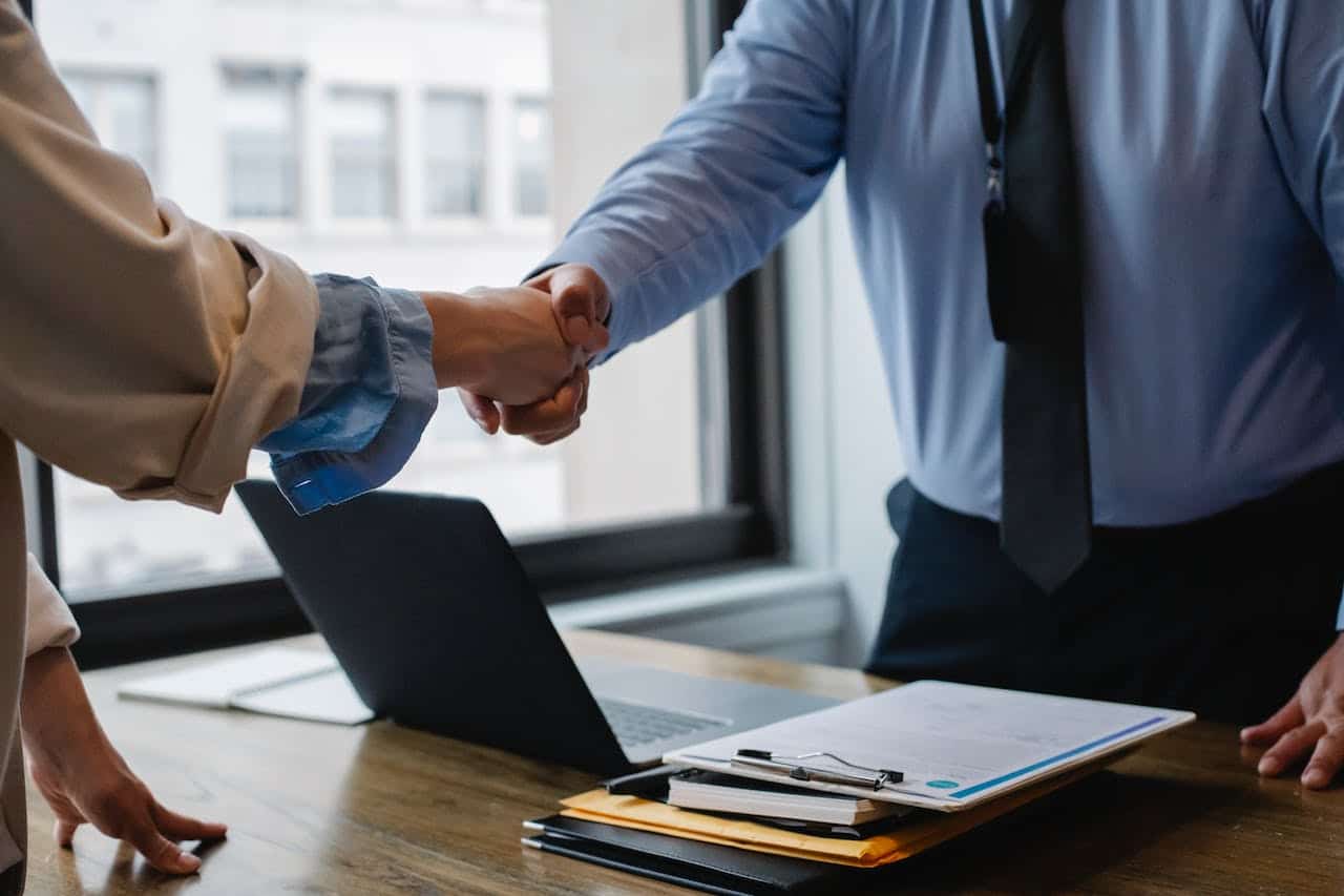 Photo by Sora Shimazaki: https://www.pexels.com/photo/crop-colleagues-shaking-hands-in-office-5673488/ -- client sale