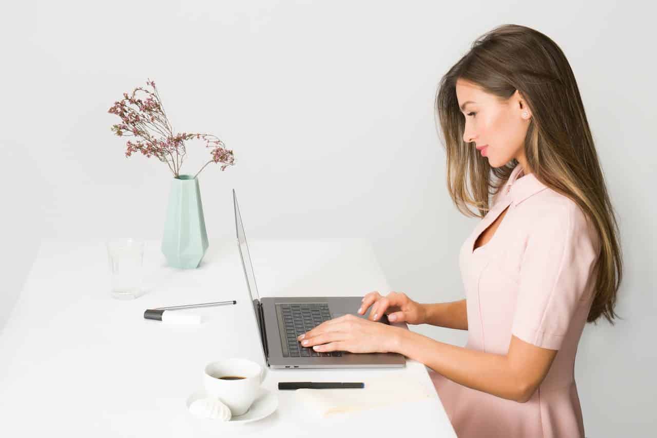 Photo by Moose Photos: https://www.pexels.com/photo/woman-in-pink-dress-using-laptop-computer-1586973/ -- event planner