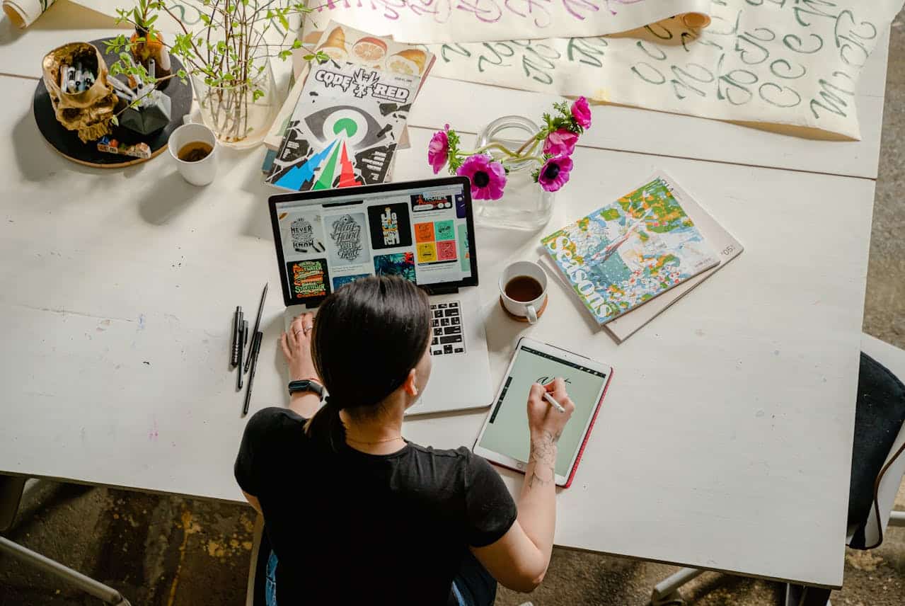 Photo by Antoni Shkraba: https://www.pexels.com/photo/photo-of-woman-writing-on-tablet-computer-while-using-laptop-4348401/ -- creative branding