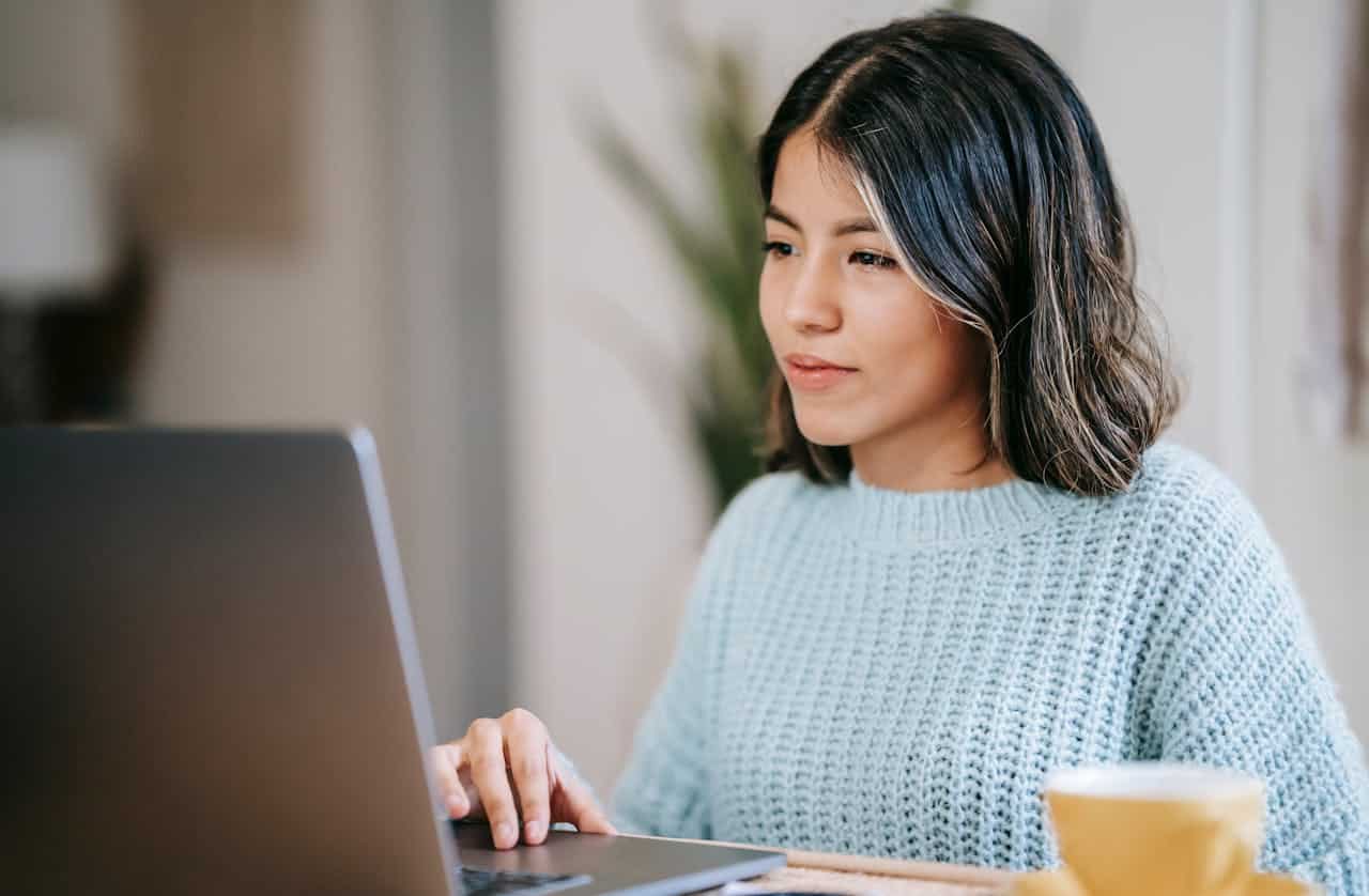 Pexels Photo by Liza Summer: https://www.pexels.com/photo/hispanic-female-student-using-laptop-near-tea-mug-in-room-6347902/ -- event professional at the computer