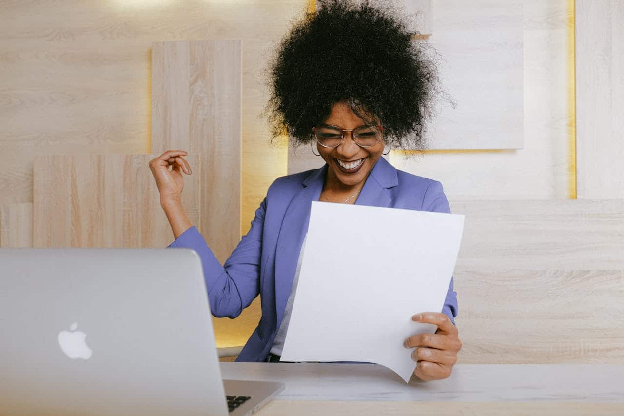 Photo by Anna Shvets: https://www.pexels.com/photo/woman-holding-a-paper-3727463/ -- corporate event win