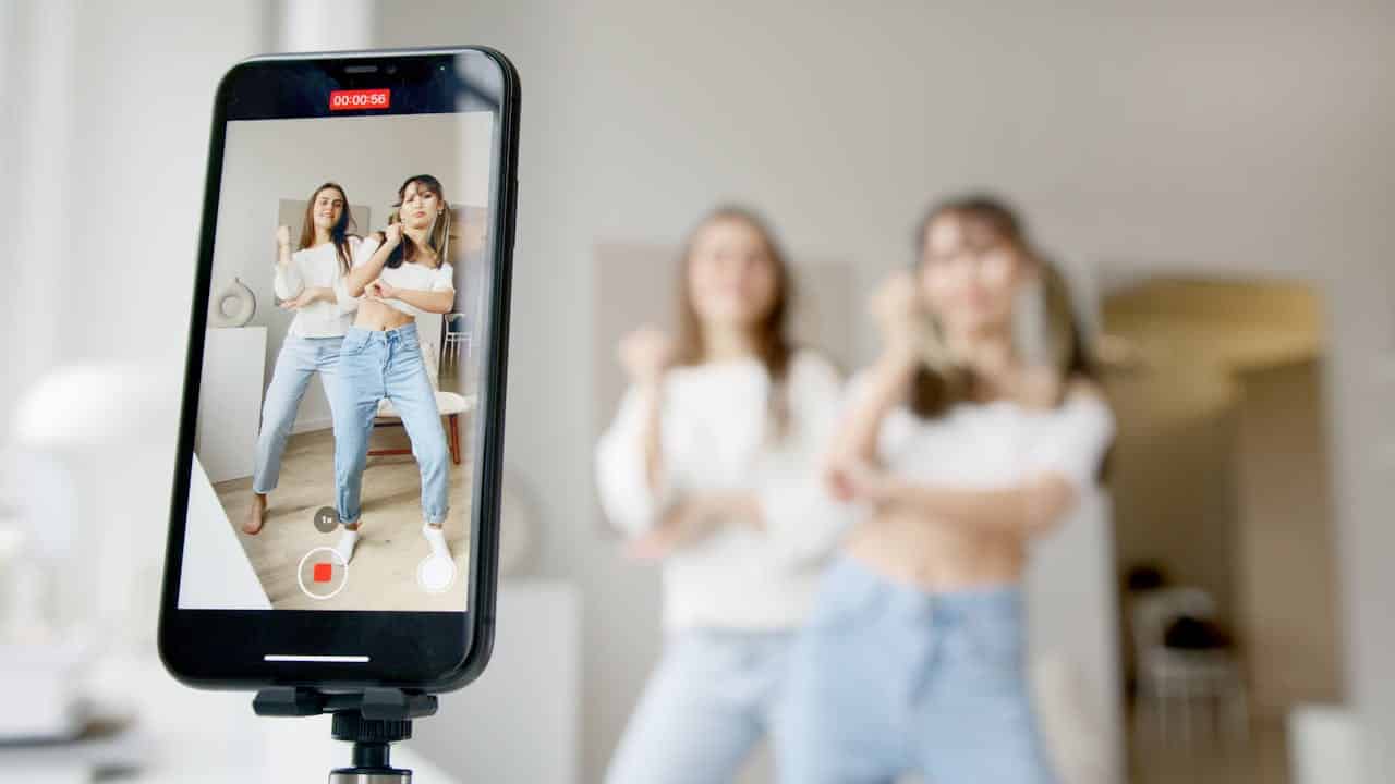 Photo by Artem Podrez: https://www.pexels.com/photo/women-recording-using-a-smartphone-6003271/ -- influencers