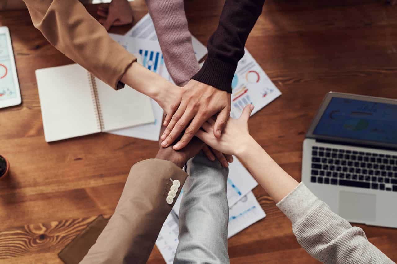 Photo by fauxels: https://www.pexels.com/photo/photo-of-people-near-wooden-table-3184418/ -- event planning collaboration