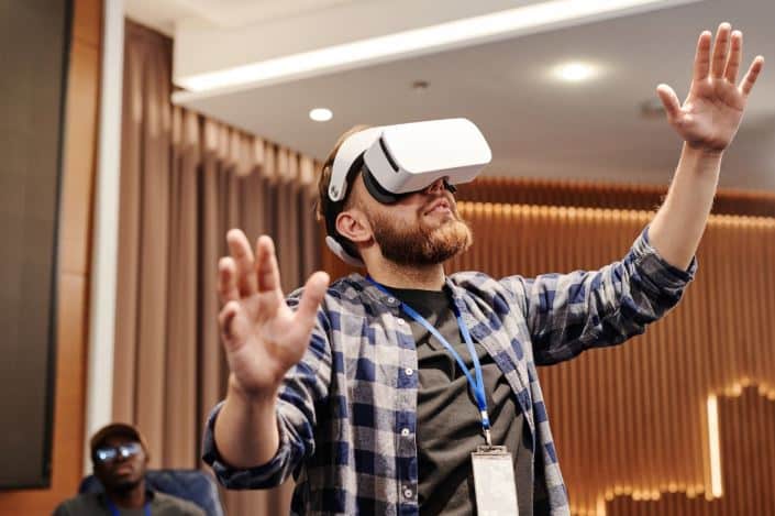 Photo by Henri Mathieu-Saint-Laurent: https://www.pexels.com/photo/man-wearing-virtual-reality-headset-raising-his-hands-8348740/ - Experiential Event