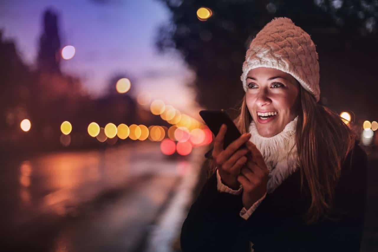 Photo by Andrea Piacquadio: https://www.pexels.com/photo/cheerful-woman-recording-voice-message-on-smartphone-in-street-3783519/