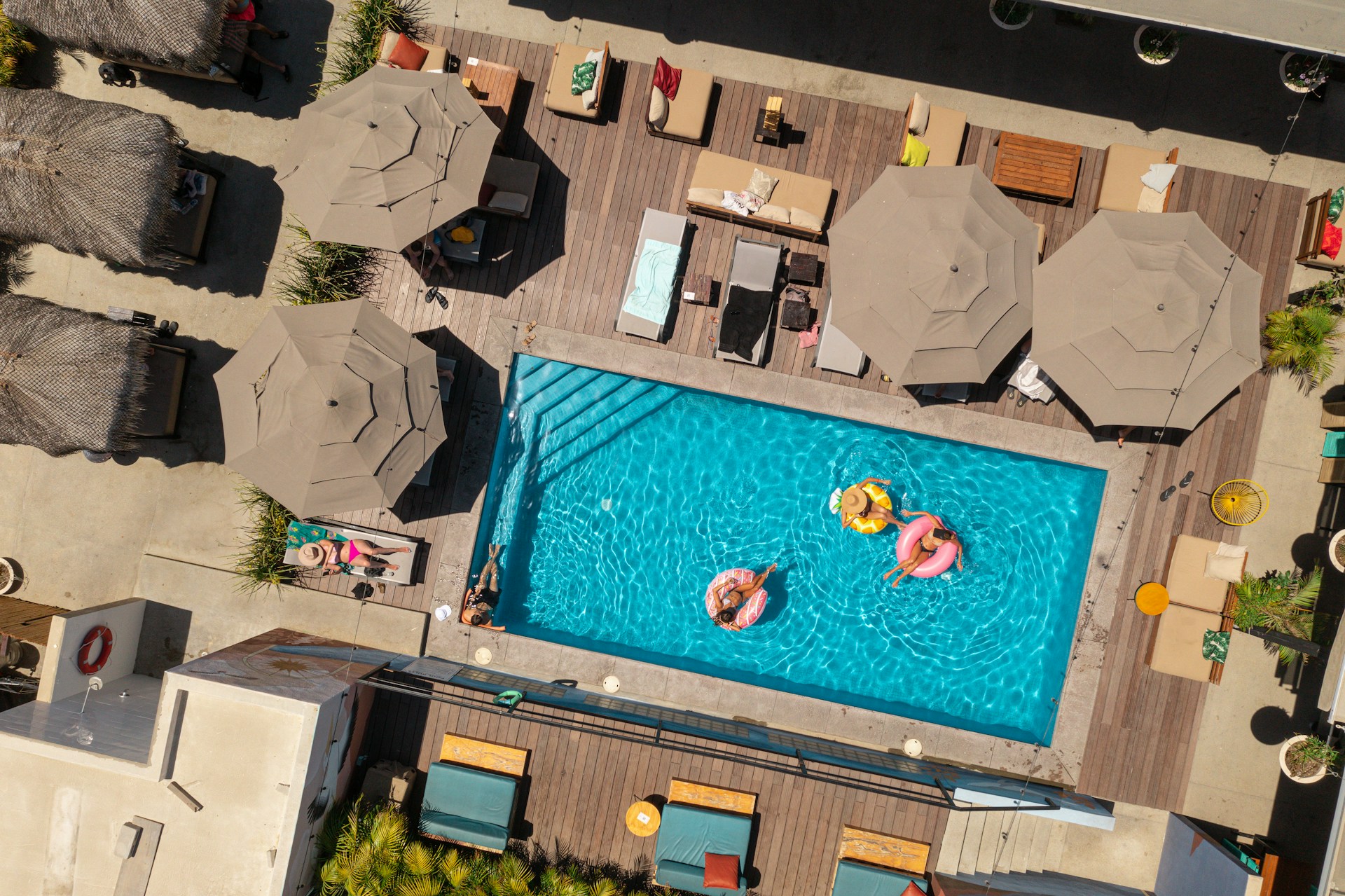 https://unsplash.com/photos/an-aerial-view-of-a-pool-with-lounge-chairs-and-umbrellas-RDYb4pDmc1E Photo by Carlos Gilbert on Unsplash