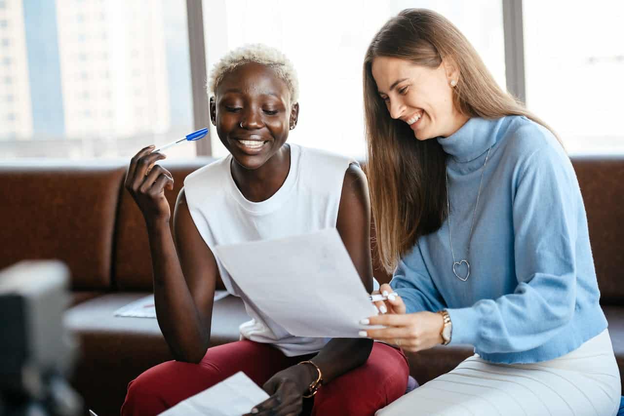 Photo by Alexander Suhorucov: https://www.pexels.com/photo/cheerful-multiethnic-colleagues-discussing-contract-in-office-6457520/ -- collabs
