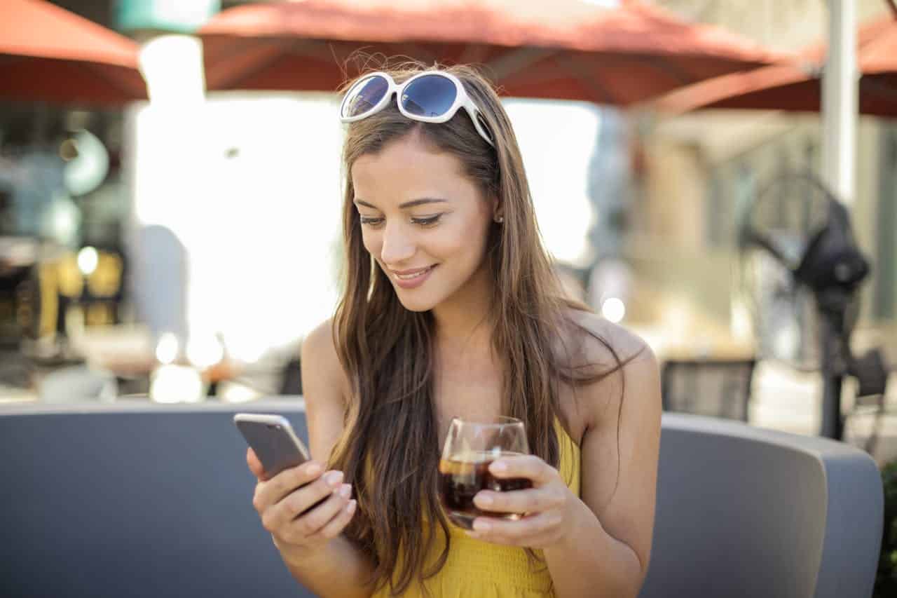Photo by Andrea Piacquadio: https://www.pexels.com/photo/woman-holding-smartphone-and-drinking-glass-3812756/